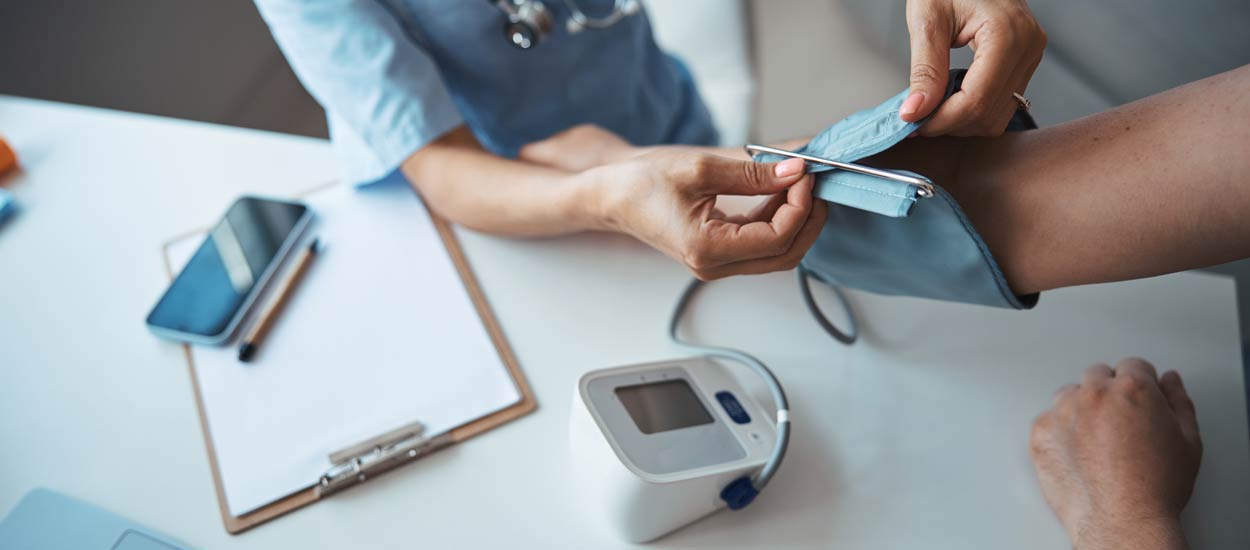 female-doctor-checking-patient-blood-pressure