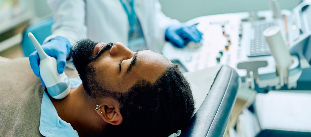 african-american-man-having-thyroid-exam-with-ultr-2023-06-07-18-00-30-utc